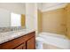 Bathroom showcasing a granite countertop vanity and tiled shower and tub combo at 6925 Trellis Vine Loop, Windermere, FL 34786