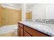 Bathroom featuring a double sink with granite countertops and a tiled shower/tub combo at 6925 Trellis Vine Loop, Windermere, FL 34786