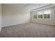 Spacious bedroom with three large windows and neutral carpet at 6925 Trellis Vine Loop, Windermere, FL 34786