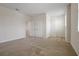 Spacious bedroom featuring neutral carpet, white walls, and a closet for ample storage at 6925 Trellis Vine Loop, Windermere, FL 34786