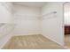 Walk-in closet with carpeted flooring and metal shelving at 6925 Trellis Vine Loop, Windermere, FL 34786