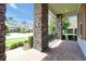 Covered front porch with brick columns and paved flooring, overlooking the street and landscaped yard at 6925 Trellis Vine Loop, Windermere, FL 34786