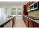 Spacious kitchen with granite countertops, stainless steel dishwasher, and tile flooring at 6925 Trellis Vine Loop, Windermere, FL 34786