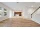 Inviting living space showcasing an open layout with wood flooring, a staircase, and a view into the kitchen at 6925 Trellis Vine Loop, Windermere, FL 34786