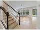 Living room with natural light, neutral walls, stairs and wood-look flooring at 6925 Trellis Vine Loop, Windermere, FL 34786