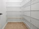 Walk-in pantry featuring metal shelving and tile flooring at 6925 Trellis Vine Loop, Windermere, FL 34786