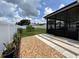 View of fenced backyard from patio, including small tree and garden area from a covered and screened patio at 7601 Fort Sumter Dr, Orlando, FL 32822