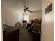 This bedroom contains boxes, a bed, chair, end table, window, and overhead light at 7601 Fort Sumter Dr, Orlando, FL 32822