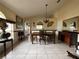 Elegant dining room features tile floors, chandelier, and stylish furnishings at 7601 Fort Sumter Dr, Orlando, FL 32822