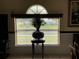 Close-up of dining area window and vase, with natural light streaming in at 7601 Fort Sumter Dr, Orlando, FL 32822