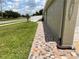 The side of the home features custom multi-colored paving stones and green lawn at 7601 Fort Sumter Dr, Orlando, FL 32822