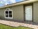 The side entrance to the home has custom multi-colored paving stones and a well-kept lawn at 7601 Fort Sumter Dr, Orlando, FL 32822