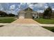 Inviting single-story home featuring a neutral stucco facade, attached garage, and manicured lawn at 7601 Fort Sumter Dr, Orlando, FL 32822