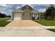 Charming single-story home with a light tan stucco exterior and well-maintained front yard at 7601 Fort Sumter Dr, Orlando, FL 32822