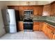 Modern kitchen with stainless steel appliances and beautiful wood cabinetry at 7601 Fort Sumter Dr, Orlando, FL 32822