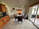 Open kitchen nook with a dark wood dining set near sliding doors at 7601 Fort Sumter Dr, Orlando, FL 32822