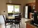 The kitchen offers stainless steel appliances and wood cabinets, conveniently located next to the dining area at 7601 Fort Sumter Dr, Orlando, FL 32822