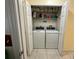 Laundry closet contains a full size washer and dryer plus overhead storage shelves at 7601 Fort Sumter Dr, Orlando, FL 32822