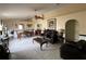 Spacious living room with tile floors, large arched windows and leather seating at 7601 Fort Sumter Dr, Orlando, FL 32822