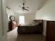 Serene main bedroom with a ceiling fan, warm color scheme, and tile flooring, creating a comfortable atmosphere at 7601 Fort Sumter Dr, Orlando, FL 32822