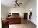 Cozy main bedroom featuring a large bed, ceiling fan, and tiled floor, providing a relaxing retreat at 7601 Fort Sumter Dr, Orlando, FL 32822