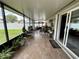 Covered and screened-in back patio with view through sliding glass doors of the fenced-in backyard at 7601 Fort Sumter Dr, Orlando, FL 32822