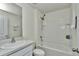 Bright bathroom with a shower and tub combination, crisp white tile, and modern fixtures at 8618 Sw 46Th Ave, Ocala, FL 34476