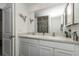 Well-lit bathroom with double vanity sinks, a large mirror, and modern fixtures at 8618 Sw 46Th Ave, Ocala, FL 34476