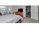 Cozy bedroom with natural light, carpeted floor, and dresser featuring a modern, wall-mounted television at 8618 Sw 46Th Ave, Ocala, FL 34476