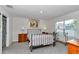 Inviting bedroom with carpet, a window offering natural light, and a neutral color scheme at 8618 Sw 46Th Ave, Ocala, FL 34476