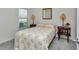 Bedroom features cozy bed with two side tables, lamps, and a bright window view at 8618 Sw 46Th Ave, Ocala, FL 34476