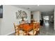 Dining area featuring a wooden table, seating for six, and a decorative tree art piece on the wall at 8618 Sw 46Th Ave, Ocala, FL 34476