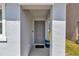 Close-up of front door with a neutral color, covered entryway, and space for decorative planters at 8618 Sw 46Th Ave, Ocala, FL 34476