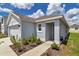 Home's front exterior with well-maintained landscaping, covered porch, and a pathway to the front door at 8618 Sw 46Th Ave, Ocala, FL 34476