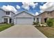 Inviting home exterior featuring a well-manicured lawn, covered entryway, and a spacious driveway at 8618 Sw 46Th Ave, Ocala, FL 34476