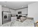 Bright kitchen featuring stainless steel appliances, white cabinets, and granite countertops at 8618 Sw 46Th Ave, Ocala, FL 34476