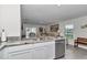 Kitchen showcasing granite countertops, stainless steel appliances, and a view of the living area at 8618 Sw 46Th Ave, Ocala, FL 34476