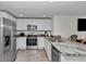 Bright kitchen equipped with stainless steel appliances, granite countertops, and white cabinetry at 8618 Sw 46Th Ave, Ocala, FL 34476