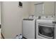 Bright laundry room with front-loading washer and dryer and window offering natural light at 8618 Sw 46Th Ave, Ocala, FL 34476