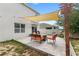 View of backyard patio with outdoor seating, pergola and manicured landscaping at 9024 Alba Ln, Kissimmee, FL 34747