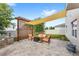 Backyard patio area has stylish pavers, wooden pergola and attractive outdoor furniture at 9024 Alba Ln, Kissimmee, FL 34747