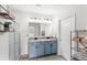 Modern bathroom with double vanity, granite countertop, and walk-in shower with glass door at 9024 Alba Ln, Kissimmee, FL 34747
