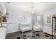 Bedroom features a crib, chair, dresser, modern chandelier, and area rug at 9024 Alba Ln, Kissimmee, FL 34747