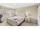 Comfortable bedroom with neutral decor, natural light from window, and light colored furniture at 9024 Alba Ln, Kissimmee, FL 34747