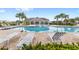 Community pool with lounge chairs and a covered patio area at 9024 Alba Ln, Kissimmee, FL 34747