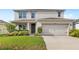 Charming two-story home featuring a two-car garage and well-maintained landscaping at 9024 Alba Ln, Kissimmee, FL 34747