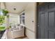 Inviting front porch with seating area, plants and view of front door at 9024 Alba Ln, Kissimmee, FL 34747