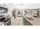 Bright open kitchen featuring granite countertops, stainless steel appliances, and white cabinets at 9024 Alba Ln, Kissimmee, FL 34747