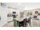 Bright kitchen features white cabinets, stainless appliances, granite countertops, tile backsplash, and kitchen island at 9024 Alba Ln, Kissimmee, FL 34747