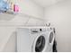 Laundry area features a side-by-side washer and dryer, plus wire shelving at 9024 Alba Ln, Kissimmee, FL 34747
